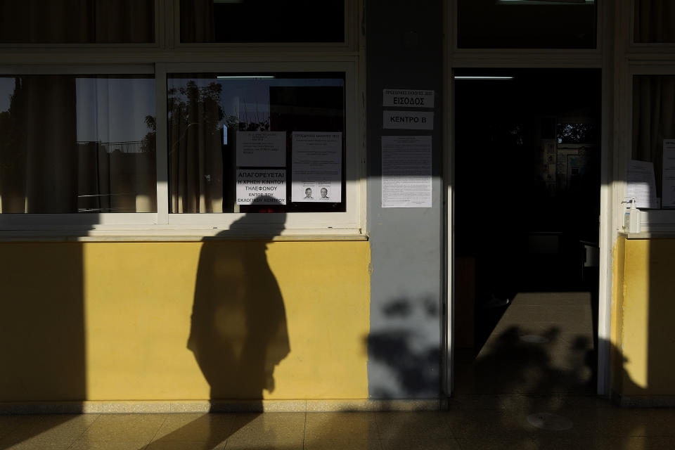 A shadow of an elderly voter passes outside of a polling station during the presidential election in Geroskipou in southwest coastal city of Paphos, Cyprus, Sunday, Feb. 12, 2023. Voting has started in a runoff to elect ethnically split Cyprus' eighth new president, pitting a former foreign minister who campaigned as a unifier eschewing ideological and party divisions against a popular veteran diplomat.(AP Photo/Petros Karadjias)