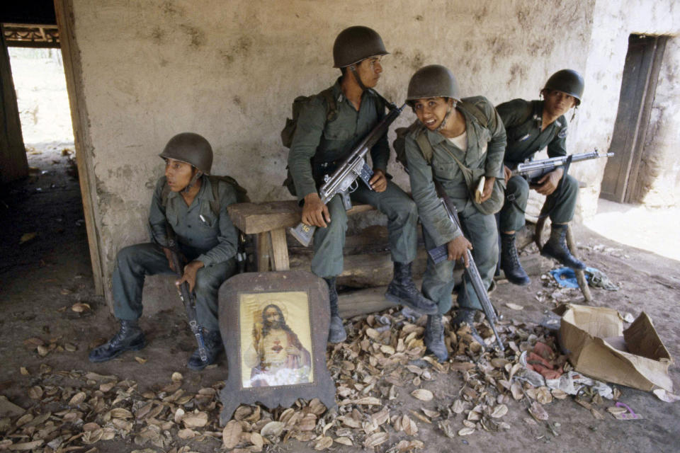 FILE - Salvadoran troops rest on the porch of a deserted farm house between Suchitoto and San Jose Guayabal, El Salvador, March 1981. Pat Hamilton, a combat veteran of the Vietnam War who covered the civil wars in Central America as a photojournalist for The Associated Press, and who later worked at Reuters covering the Gulf War in Iraq, died Sunday, Aug. 13, 2023, after a long struggle with cancer. He was 74. (AP Photo/Pat Hamilton, File)