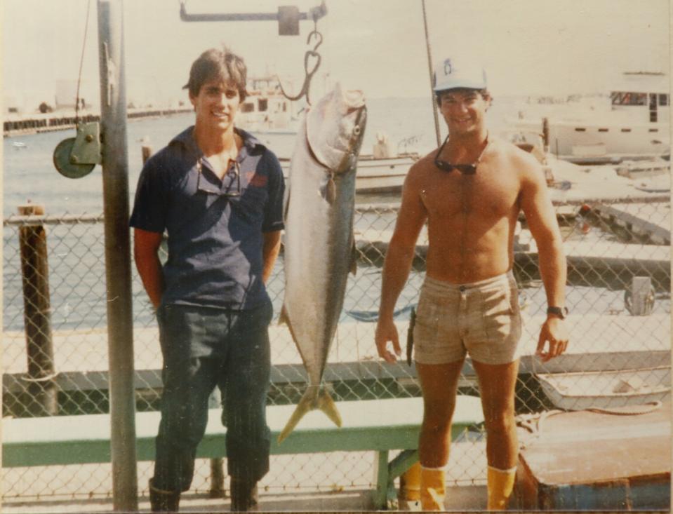 Two men with a fish they caught