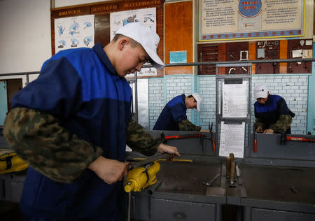 Students practice during a metal work class at a college of ferrous metallurgy in the town of Aksu, north-eastern Kazakhstan, February 22, 2018. REUTERS/Shamil Zhumatov