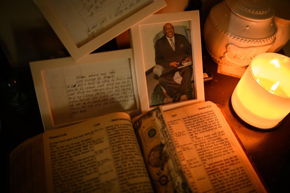 A photo of Marvin Frink’s father, along with his father’s Bible and a couple of handwritten notes from his father, sit on a table in the foyer of the Frink home.