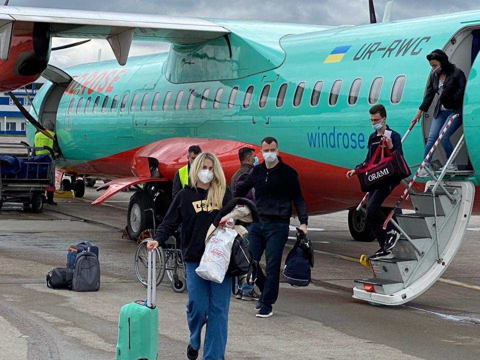 Passengers with masks on deplaning a Windrose ATR in 2019.
