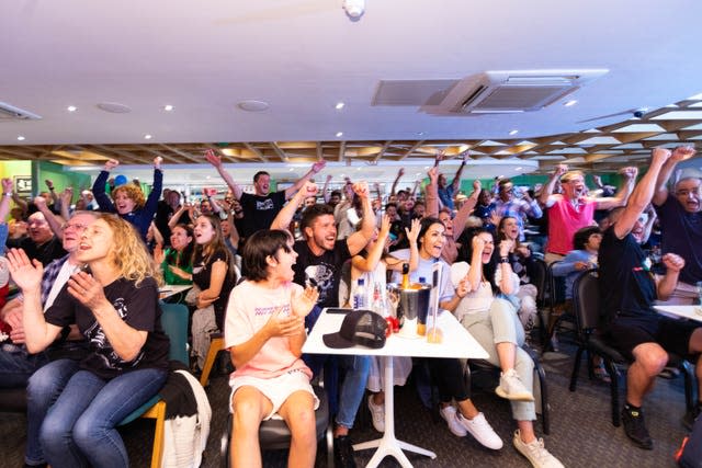 Fans at the Parklangley Club in Beckenham, celebrate Emma Raducanu winning the US Open Final (David Parry/PA)