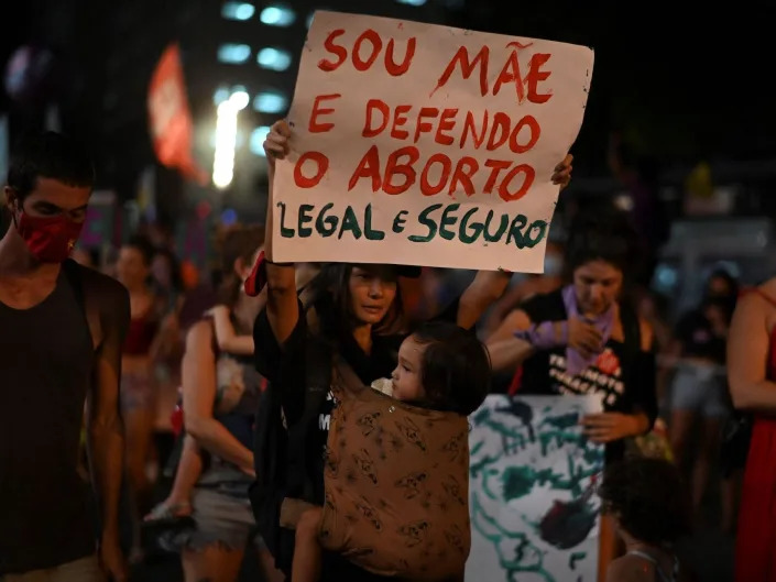 A woman holds a sign in support of legal abortion during a demonstration to commemorate the International Womens Day at the city center of Rio de Janeiro, Brazil, March 08, 2022.