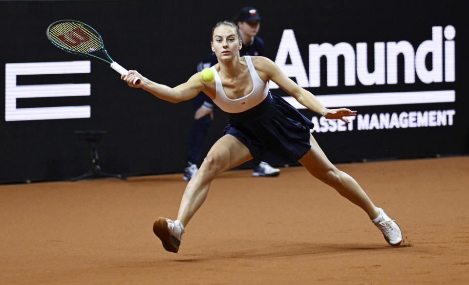 Ukraine's Marta Kostjuk returns the ball to Kazakhstan's Elena Rybakina during the Women Singles Final tennis match of Stuttgart, Germany, Sunday April 21, 2024. (Marijan Murat/dpa via AP)