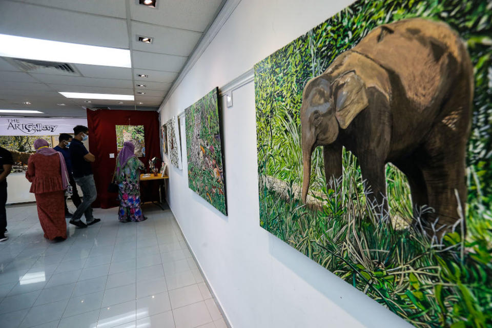 The family of the late Nasir Nadzir view some of the painting made by Nasir during the exhibition held at The Art Gallery, Pulau Tikus May 7, 2021. — Picture by Sayuti Zainudin