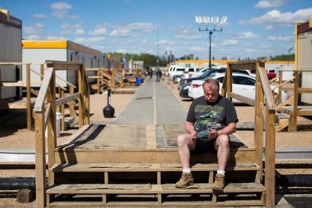 Dave Crowley waits for updated about the raging wildfires while staying at a camp in Wandering River after evacuating Fort McMurray, Alberta, Canada, on May 8, 2016. REUTERS/Topher Seguin