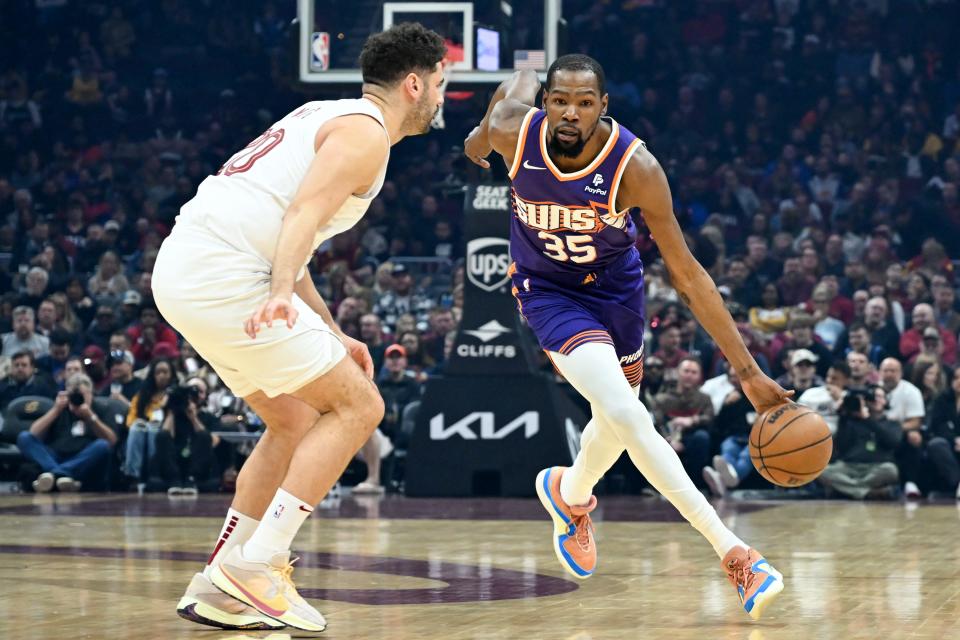 Kevin Durant #35 of the Phoenix Suns drives against Georges Niang #20 of the Cleveland Cavaliers during the first half at Rocket Mortgage Fieldhouse on March 11, 2024, in Cleveland, Ohio.