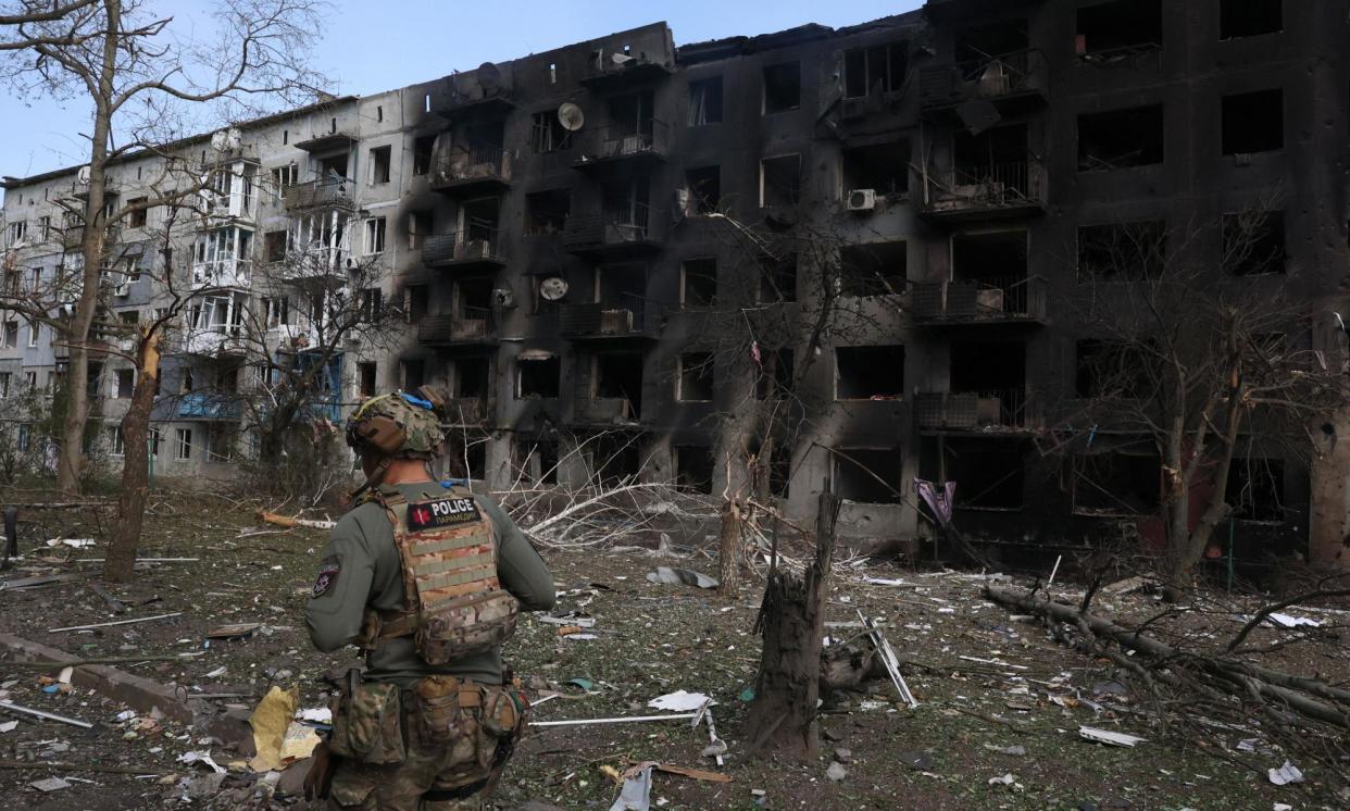 <span>A Ukrainian police officer walks past a destroyed residential building in Ocheretyne. Russian forces have now reportedly entered the village.</span><span>Photograph: Anatolii Stepanov/AFP/Getty Images</span>