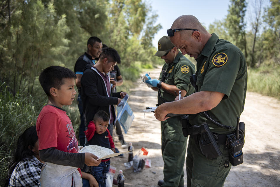 Border Patrol agents with detained illegal immigrants