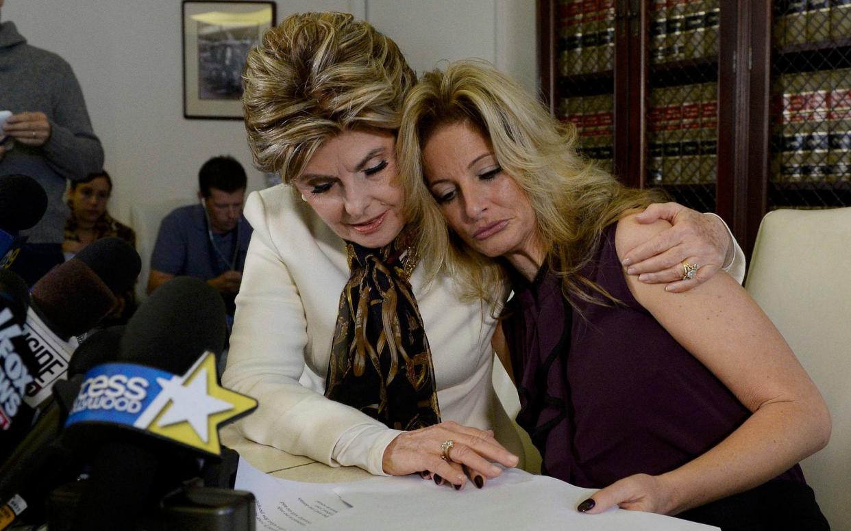 Summer Zervos, right, with her lawyer Gloria Allred, makes the accusations against Donald Trump at a news conference in October - KEVORK DJANSEZIAN/AP