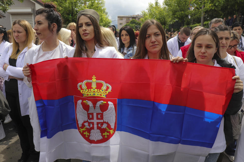 People attend a protest rally in front of the city hall in the town of Zvecan, northern Kosovo, Wednesday, May 31, 2023. Hundreds of ethnic Serbs began gathering in front of the city hall in their repeated efforts to take over the offices of one of the municipalities where ethnic Albanian mayors took up their posts last week. (AP Photo/Bojan Slavkovic)