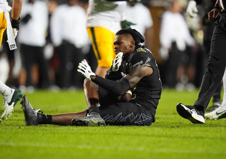 Aug 29, 2024; Boulder, Colorado, USA; Colorado Buffaloes wide receiver Travis Hunter (12) reacts on the turf after a reception in the second half against the North Dakota State Bison at Folsom Field. Mandatory Credit: Ron Chenoy-USA TODAY Sports