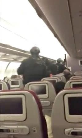 Armed police remove a man from Malaysia Airlines flight MH128 at Tullamarine Airport, Melbourne, Australia in this still frame taken from June 1, 2017 video. Selena Brown/Handout via REUTERS TV