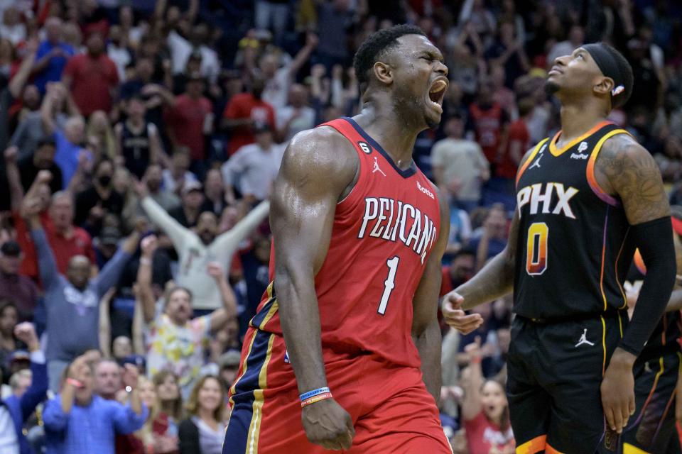 New Orleans Pelicans forward Zion Williamson (1) celebrates next to Phoenix Suns forward Torrey Craig (0) after dunking in the second half of an NBA basketball game in New Orleans, Friday, Dec. 9, 2022. (AP Photo/Matthew Hinton)