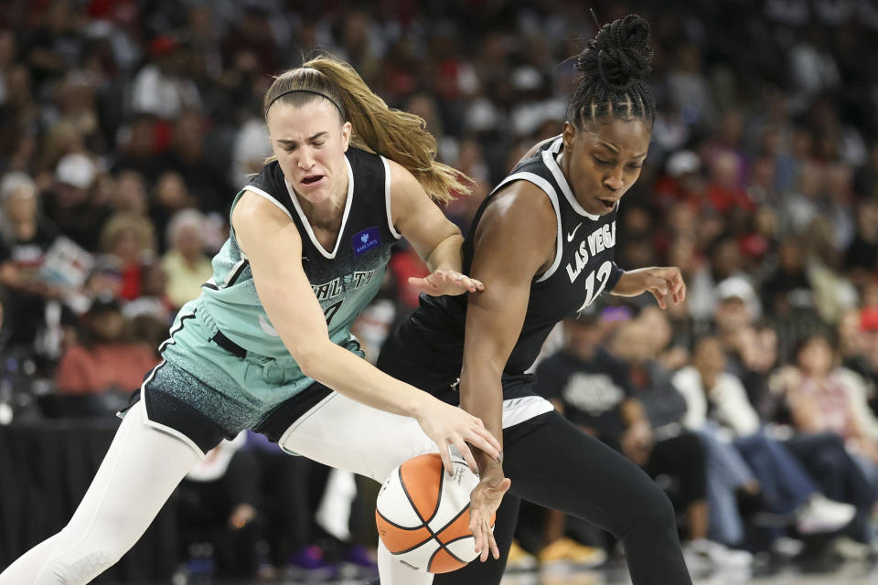 Las Vegas Aces guard Chelsea Gray knocks the ball away from New York Liberty guard Sabrina Ionescu (20) during the first half of a WNBA Semifinal basketball game, Sunday, Oct. 6, 2024, in Las Vegas. (AP Photo/Ian Maule)