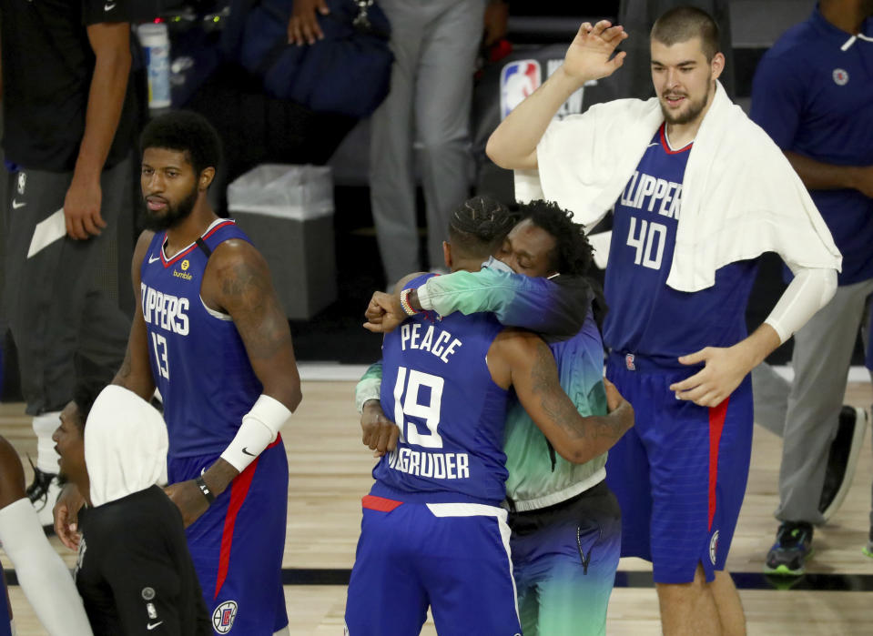 Los Angeles Clippers' Rodney McGruder (19) celebrates with teammates after beating the Portland Trail Blazers in an NBA basketball Saturday, Aug. 8, 2020, in Lake Buena Vista, Fla. (Kim Klement/Pool Photo via AP)