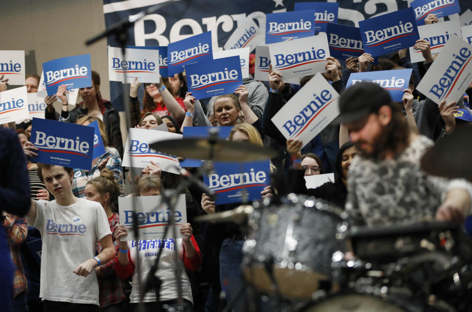 Supporters of democratic presidential candidate Sen. Bernie Sanders, I-Vt., hold up signs as Portugal. The Man performs at a campaign rally Sunday, Jan. 26, 2020, in Sioux City, Iowa. (AP Photo/John Locher)