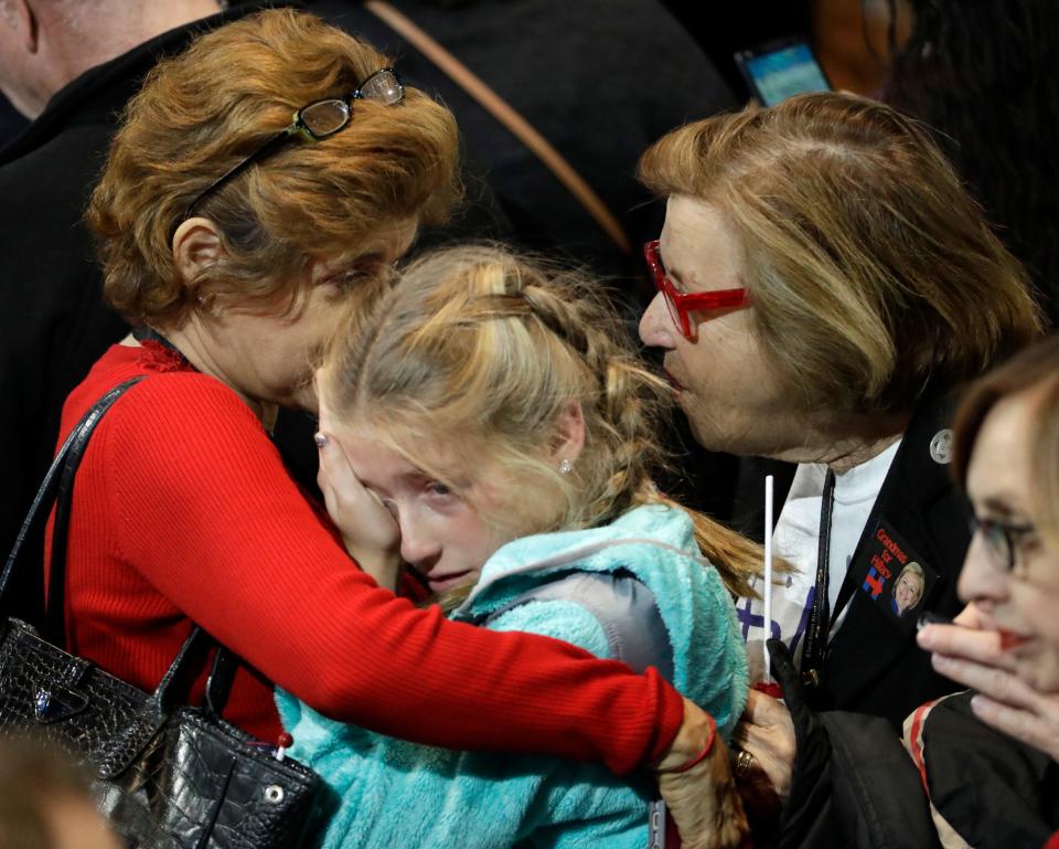 A young girl is comforted during Democratic presidential nominee Hillary Clinton's election night rally in the Jacob Javits Center lobby in New York on Nov. 8, 2016.