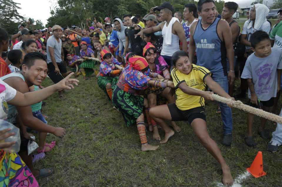 In this Nov. 25, 2018 photo, Guna indigenous women compete in the tug-of-war during the second edition of the Panamanian indigenous games in Piriati, Panama. Indigenous people from the four most important ethnic groups in Panama participated for two days of games to select the athletes who will represent Panama in the upcoming World Indigenous Peoples Games. (AP Photo/Arnulfo Franco)