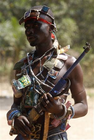 A fighter from the Christian "anti-balaka" militia holds a traditional weapon at his headquarters in the northern Bangui suburb of Boeing, an area near the Mpoko International Airport of Bangui February 22, 2014. REUTERS/Luc Gnago