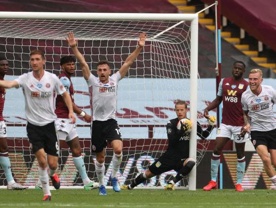 Sheffield United’s players react as Aston Villa’s Norwegian goalkeeper Orjan Nyland (C) catches the ball (AFP via Getty)