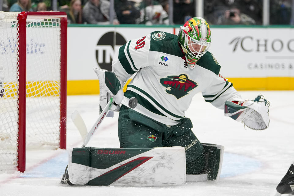 Minnesota Wild goalkeeper Jesper Wallstedt makes a save during his NHL debut during the first period of an NHL hockey game against the Dallas Stars, Wednesday, Jan. 10, 2024, in Dallas. (AP Photo/Julio Cortez)