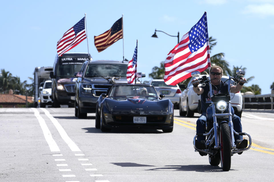 A caravan of supporters of former President Donald Trump ride past his Mar-a-Lago estate, Thursday, March 23, 2023, in Palm Beach, Fla. (AP Photo/Lynne Sladky)