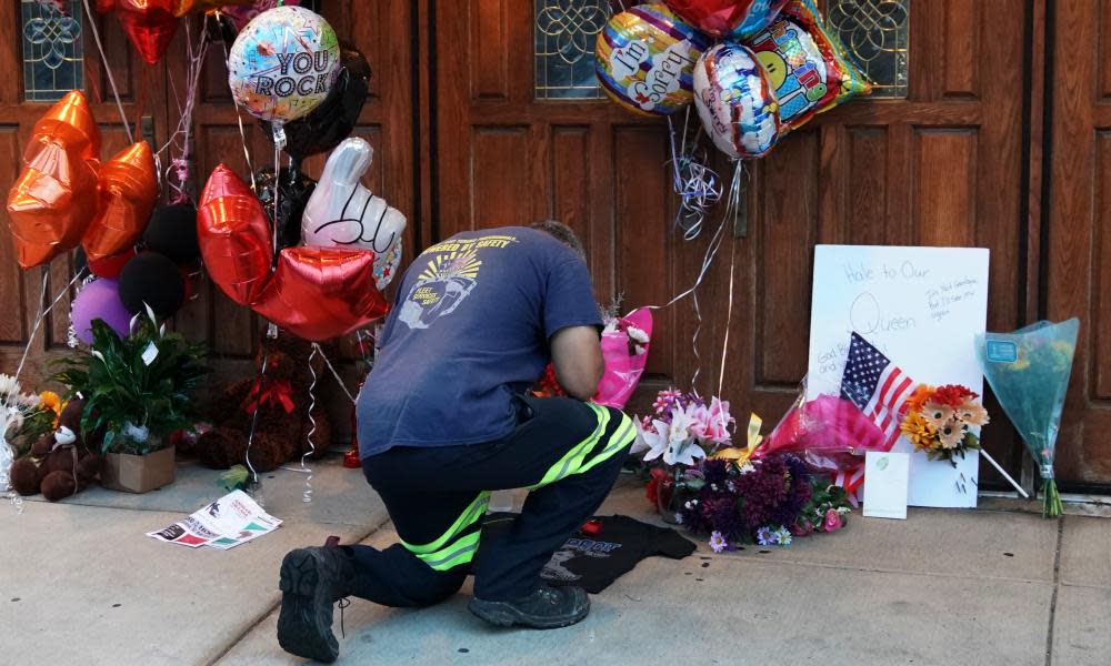 A visitor kneels as he pays his respects at a temporary memorial for Aretha Franklin at New Bethel Baptist Church in Detroit, Michigan, on 16 August.