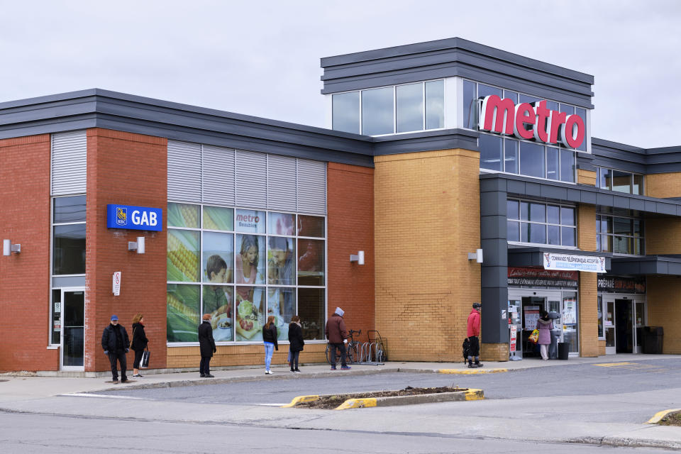 Montreal, Canada. April 11, 2020. People lining up with 2m social distancing before entering a Metro Grocery store on Easter Saturday.