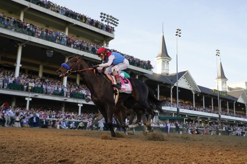 FILE - John Velazquez rides Medina Spirit across the finish line to win the 147th running of the Kentucky Derby at Churchill Downs in Louisville, Ky., May 1, 2021. Split-sample urine testing of Kentucky Derby winner Medina Spirit has shown that a steroid present in the colt's system came from a topical ointment and not an injection, according to an attorney for trainer Bob Baffert. (AP Photo/Jeff Roberson, File)