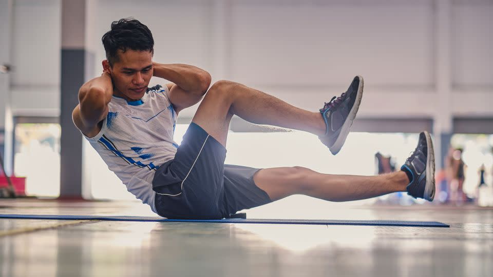 Bicycle crunches require more leg movement than a typical crunch. They're great for improving core strength, stability, flexibility and coordination. - Prasert Prapanoppasin/Moment RF/Getty Images