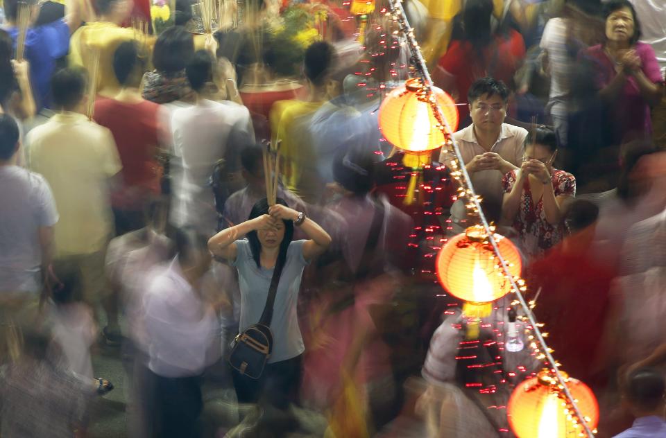 Devotees offer joss sticks ahead of the Lunar New Year at Kwan Im Thong Hood temple in Singapore