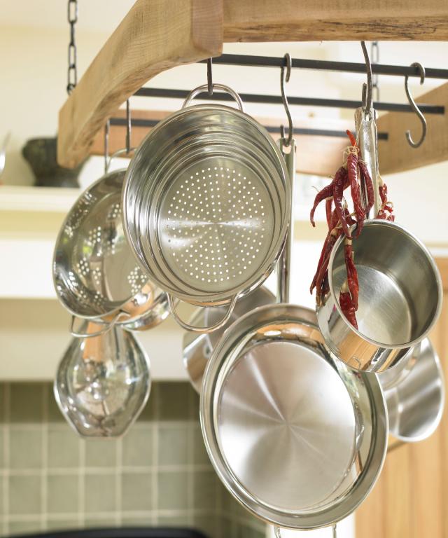 Kitchen sink with dishes on dry rack and hanging pans Stock Photo - Alamy