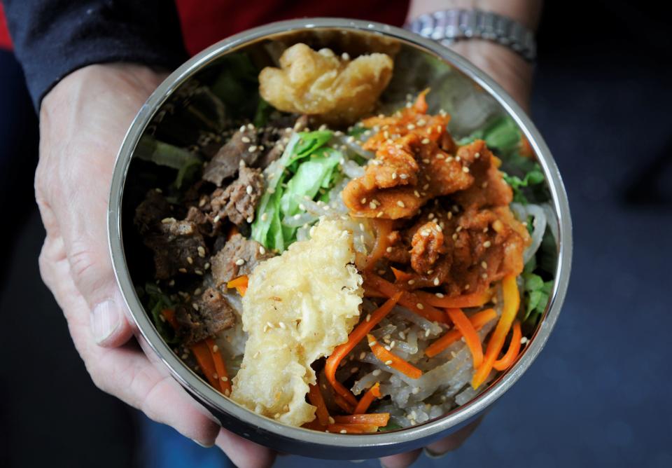 The menu at Jumak Korean restaurant is now larger and has photos to help the diner decide just what dish they want, such as this cup bap with rice, noodles, meat and vegetables.
