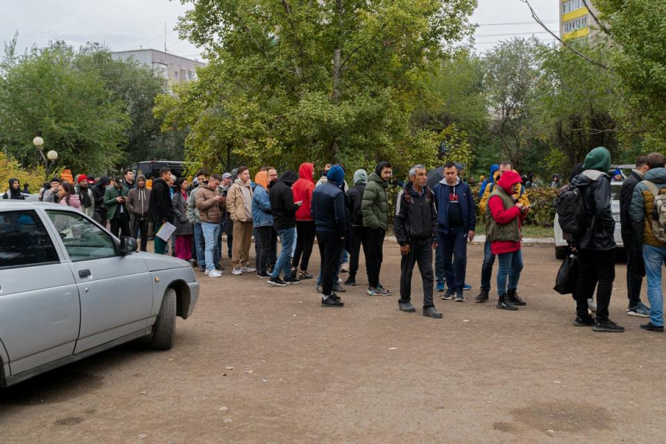 Russians line up to register after crossing the border into Kazakhstan about 250 miles south of Chelyabinsk on Wednesday (AP)
