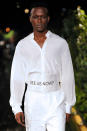 <p>In another look, a male model walks down the Pyer Moss runway wearing an all-white ensemble with a white cummerbund asking the question, “See us now?” (Photo: Getty) </p>
