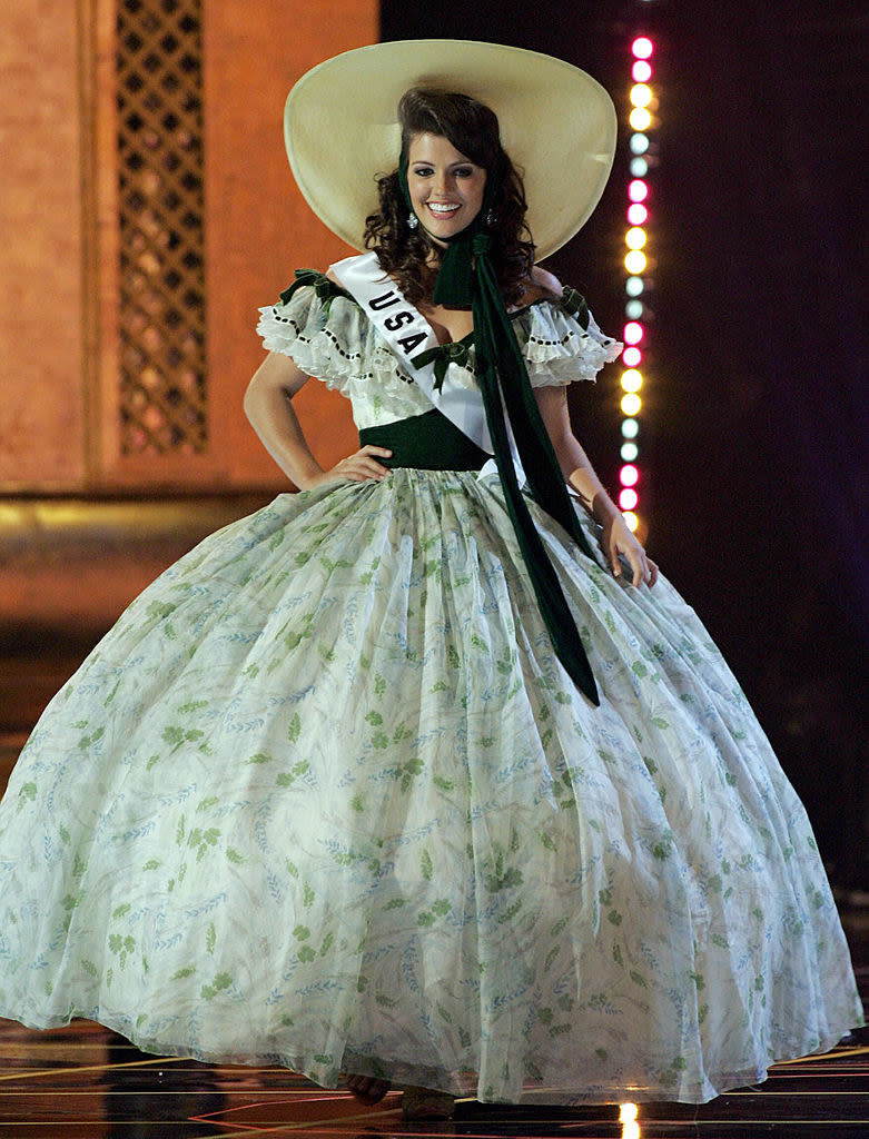 she has a large poofy dress and a big ole hat