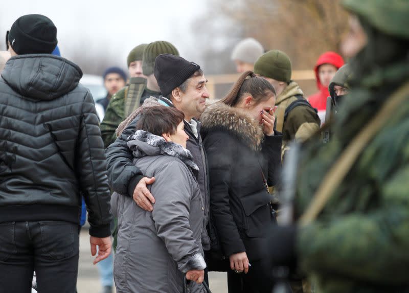 A prisoner of war is welcomed by his family members during a captives' swap between Ukraine and the separatist republics in Donetsk region