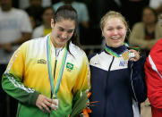 U.S. Ronda Rousey, right, shows her gold medal as Brazil's Mayra Silva stands with her on the winner's podium for the Judo Women's -70 kg middle competition at the Pan American Games in Rio de Janeiro, Friday, July 20, 2007. (AP Photo/Silvia Izquierdo)