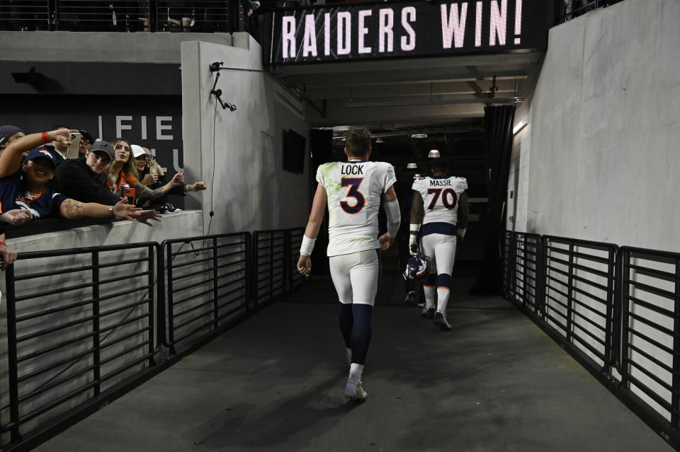 Denver Broncos quarterback Drew Lock (3) walks off the field after the Broncos lost to the Las Vegas Raiders in an NFL football game, Sunday, Dec. 26, 2021, in Las Vegas. (AP Photo/David Becker)