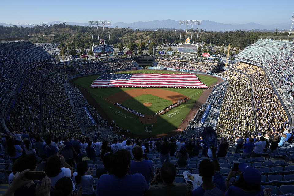 A large American flag is seen on the field during the national anthem prior to a baseball game between the Los Angeles Dodgers and the Pittsburgh Pirates Tuesday, July 4, 2023, in Los Angeles. (AP Photo/Mark J. Terrill)