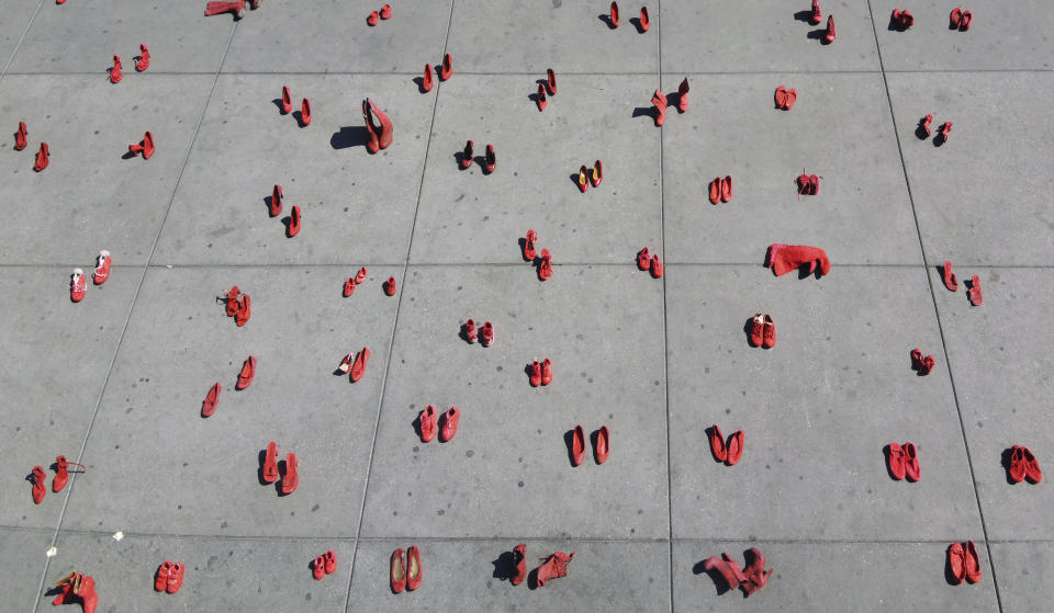 Women's red shoes are spread out in the Zocalo where they were placed by activists to protest violence against women in Mexico City, Saturday, Jan. 11, 2020. There are 10 women killed daily on average across Mexico, and only one in 10 such crimes are solved, according to the National Citizens’ Observatory on Femicide. (AP Photo/Christian Palma)