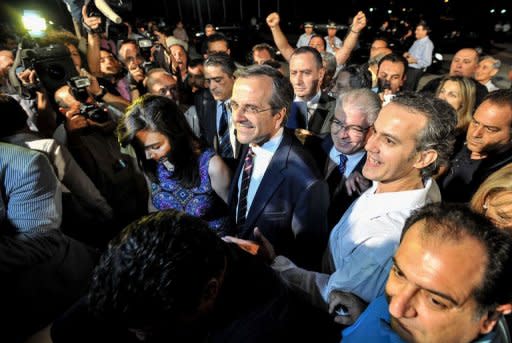 New Democracy party leader, Antonis Samaras (C) arrives for a press conference at the Zappion Hall in central Athens after his party won the Greek election. "Today the Greek people expressed their will to stay anchored with the euro," said Samaras