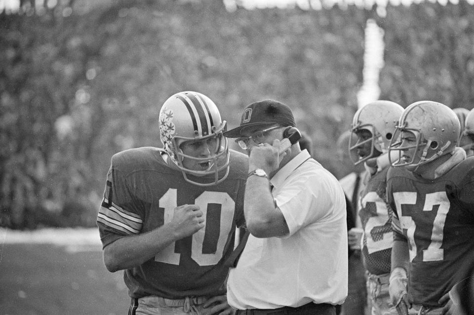 Ohio State quarterback Rex Kern and coach Woody Hayes confer during a game against Michigan on Nov. 23, 1968.