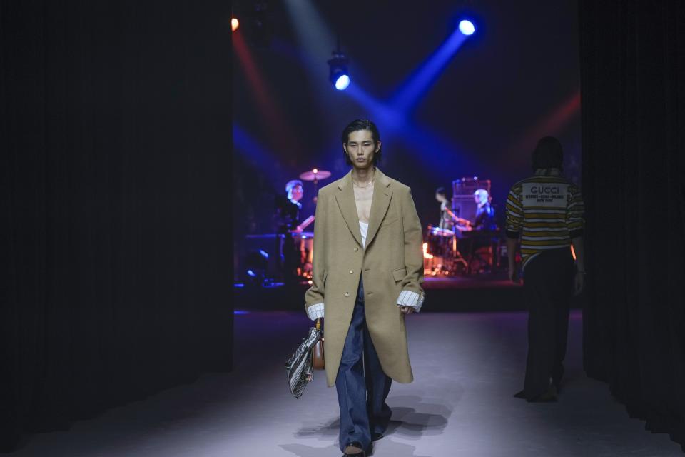 A model wears a creation as part of the Gucci menswear Fall-Winter 2023-24 collection presented in Milan, Italy, Friday, Jan. 13, 2023. (AP Photo/Antonio Calanni)