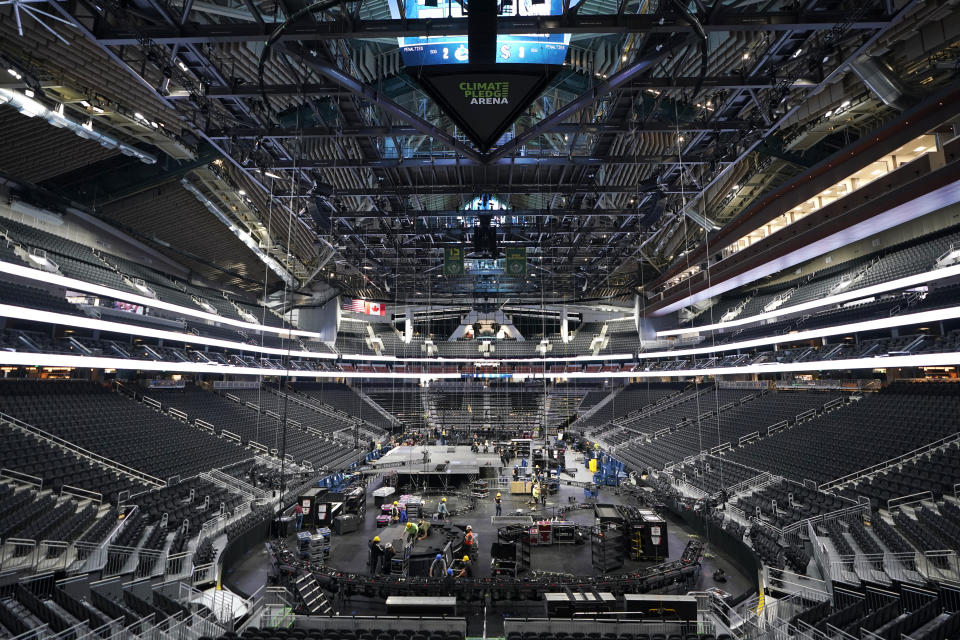 The floor and seating areas of Climate Pledge Arena are shown Wednesday, Oct. 20, 2021, during a media tour ahead of the NHL hockey Seattle Kraken's home opener Saturday against the Vancouver Canucks in Seattle. The historic angled roof of the former KeyArena was preserved, but everything else inside the arena, which will also host concerts and be the home of the WNBA Seattle Storm basketball team, is brand new. (AP Photo/Ted S. Warren)