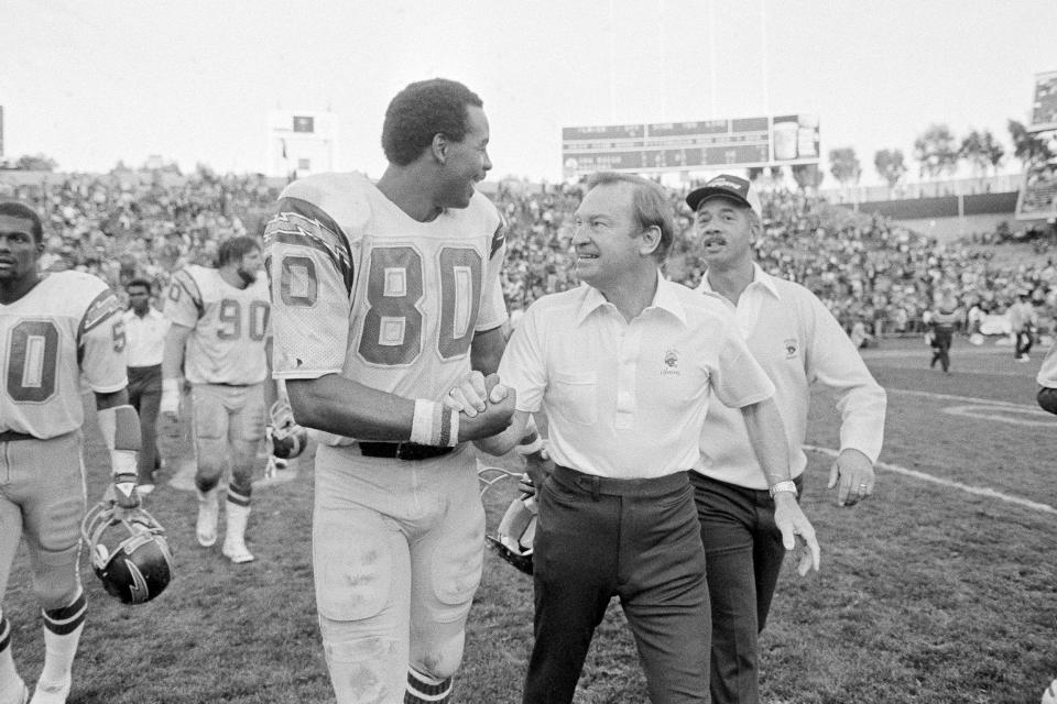 FILE - San Diego Chargers head coach Don Coryell, front right, congratulates Chargers tight end Kellen Winslow after having a great day against the Oakland Raiders in an NFL football game at Oakland Coliseum, Nov. 23, 1981. Nearly two weeks after Coryell died in 2010 at age 85, an impressive lineup of Hall of Famers gathered to remember the innovative coach whose Air Coryell offense produced some of the most dynamic passing attacks in NFL history. (AP Photo/Paul Sakuma, File)