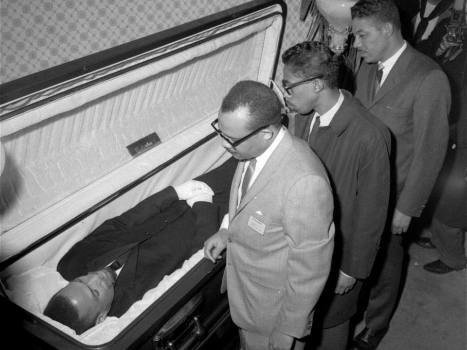 The body of Malcolm X, black nationalist leader who was slain February 21, 1965, at a rally of his organization, is viewed by newsmen at the Unity Funeral Home, Eighth Avenue and 126th Street in New York City February 24, 1965.