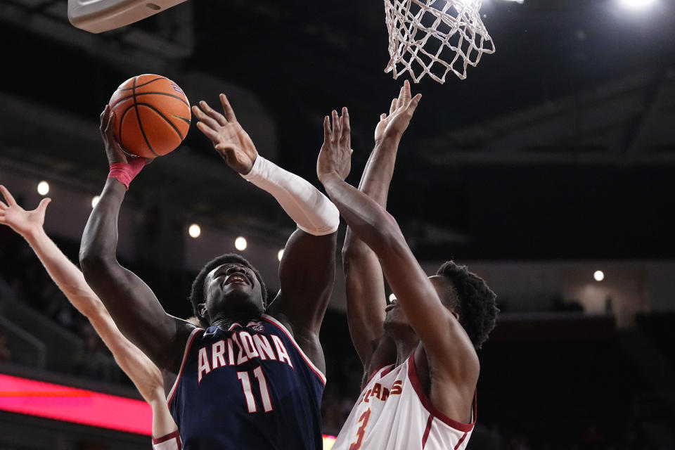 Arizona center Oumar Ballo, left, shoots as Southern California forward VIncent Iwuchukwu defends during the first half of an NCAA college basketball game Thursday, March 2, 2023, in Los Angeles. (AP Photo/Mark J. Terrill)